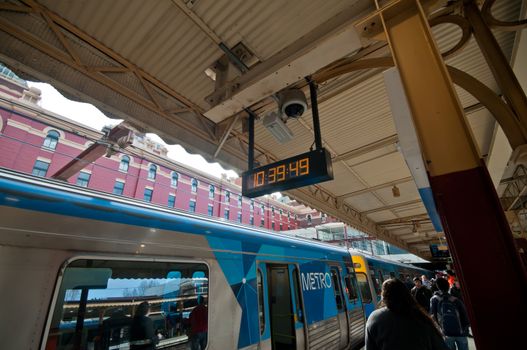 MELBOURNE, AUSTRALIA - JULY 26, 2018: Local blue Metro city train parks at Flinders street station in Melbourne Victoria Australia