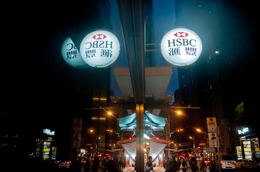 HONG KONG, HONG KONG SAR - NOVEMBER 17, 2018: Bright shiny white logo of HSBC bank branch in Central Hong Kong.