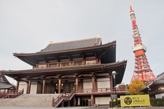 TOKYO, JAPAN - DECEMBER 1, 2018: Scene of Tokyo tower nearby Zojo-ji Buddhist temple. This is a famous temple which has the oldest wooden main gate in Tokyo built from 1622. There is nobody in the photo.