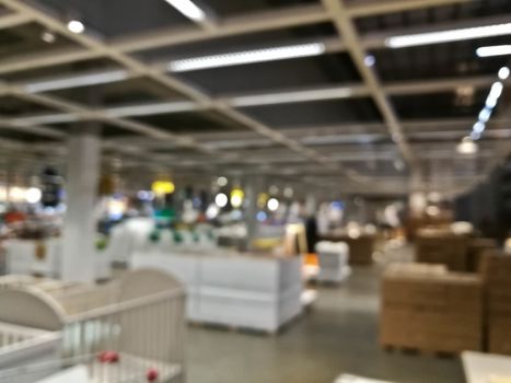 Defocused blurry scene of self service furniture indoor warehouse shop