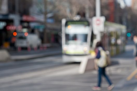 Defocussed blurred people walking near running tram in Melbourne Australia