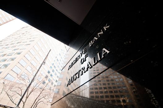 MELBOURNE, AUSTRALIA - JULY 26, 2018: Reserve Bank of Australia name on black granite wall in Melbourne Australia with a reflection of high-rise buildings. The RBA building is located at 60 Collins St, Melbourne VIC 3000 Australia.