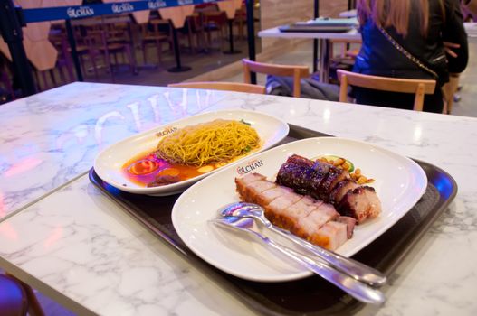 MELBOURNE, AUSTRALIA - JULY 26, 2018: BBQ and roast pork with golden egg noodle Hawker Chan Michelin stars restaurant in Melbourne Australia