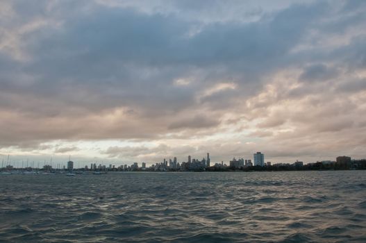 Wide angle evening scene of skyscrapers horizon with ocean and tall office and residential towers in Melbourne Australia