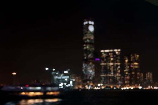 Defocused dark blurry scene of skyscrapers commercial towers in Hong Kong near Victoria Bay