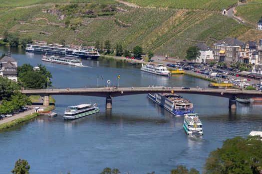 View at the valley of the river Moselle and the city of Bernkastel-Kues, the Moselle brigde and many passenger ships