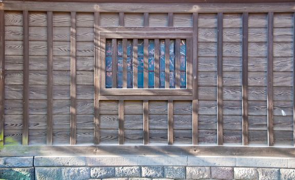 Traditional Japanese wooden house with reflection in a window to display  Autumn red orange green trees leaves