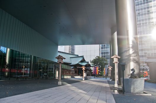 TOKYO, JAPAN - DECEMBER 1, 2018: Toranomon Kotohiragu Shrine at Minato district, which is one of the busiest business district of Tokyo. The Shinto shrine is surrounded by modern office buildings and commercial skyscrapers. The shrine is believed to bring about business success.