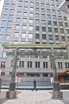 TOKYO, JAPAN - DECEMBER 1, 2018: Toranomon Kotohiragu Shrine at Minato district, which is one of the busiest business district of Tokyo. The Shinto shrine is surrounded by modern office buildings and commercial skyscrapers. The shrine is believed to bring about business success.