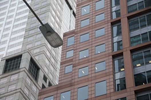 Overhead traffic lamp and modern office buildings in European city