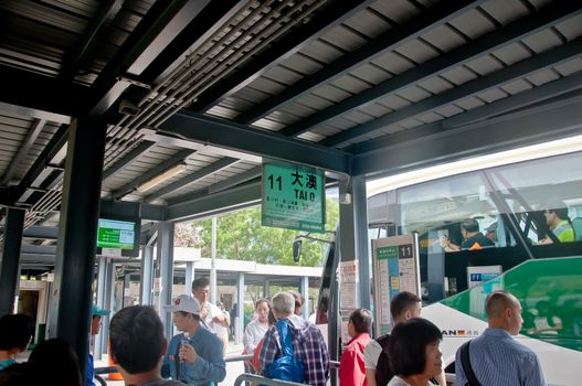 HONG KONG, HONG KONG SAR - NOVEMBER 18, 2018: Bus station no. 11 to Tai O fishing village. There are many passengers waiting to get on the bus.