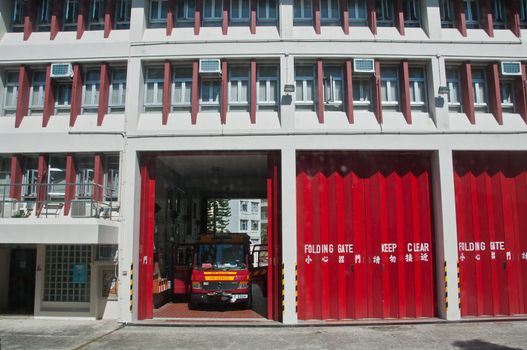 HONG KONG, HONG KONG SAR - NOVEMBER 18, 2018: Local fire station with folding gates opened ready for fire safety bus to drive out