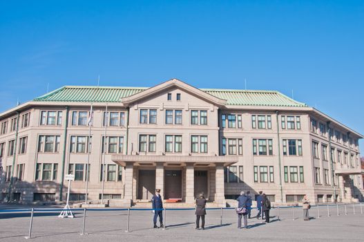 TOKYO, JAPAN - DECEMBER 1, 2018: The Imperial Household Agency - Western style strong building inside the Japanese Royal Imperial Palace. There are police guards and tourists walk around.