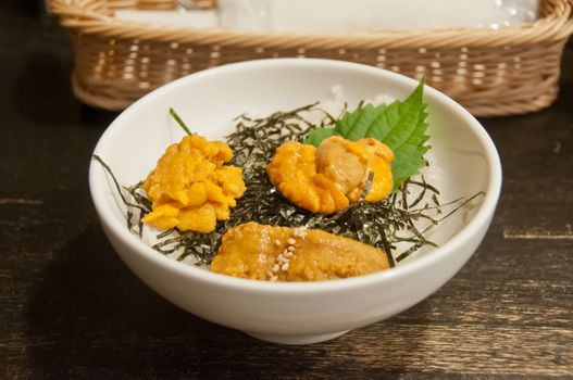 Premium supreme delicious fresh from the sea 3 types of uni sea urchin sashimi from Tokyo, Mexico, Canada on top of warm steamed rice with crispy grilled seaweed.