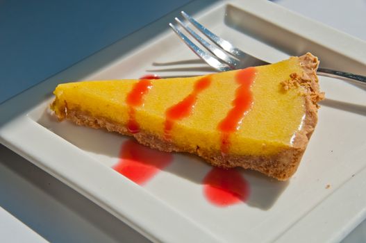 Delicious yummy light sour lemon crispy cake in white square plate and silver fork