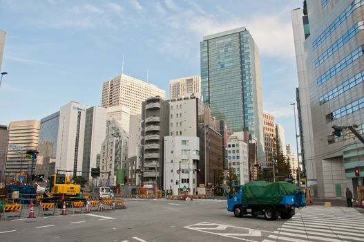 TOKYO, JAPAN - DECEMBER 1, 2018:  Japanese pedestrian stands to wait for a traffic light before crossing the road near the construction site in the morning.