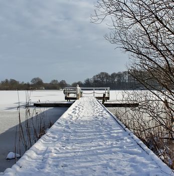 Beautiful winter shot at a lake and forest with snow and ice