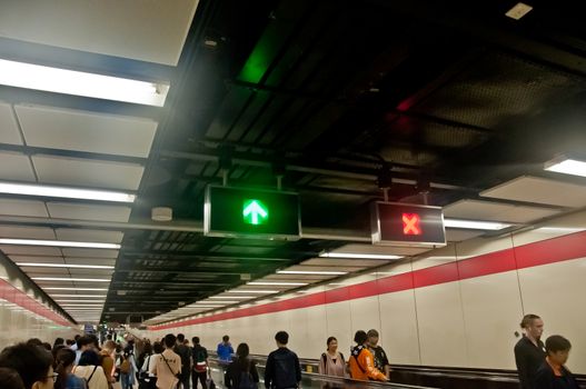 HONG KONG, HONG KONG SAR - NOVEMBER 17, 2018: Many people walks on escalator in the long Central MTR station during rush hour.