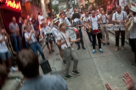 HONG KONG, HONG KONG SAR - NOVEMBER 17, 2018: Local French musician s gathers to play music for mini concert in Lan Kwai Fong Alley in the evening. There are many people in the scene.