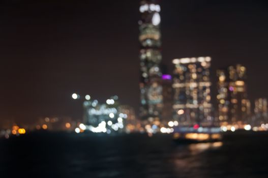 Defocused dark blurry scene of skyscrapers commercial towers in Hong Kong near Victoria Bay