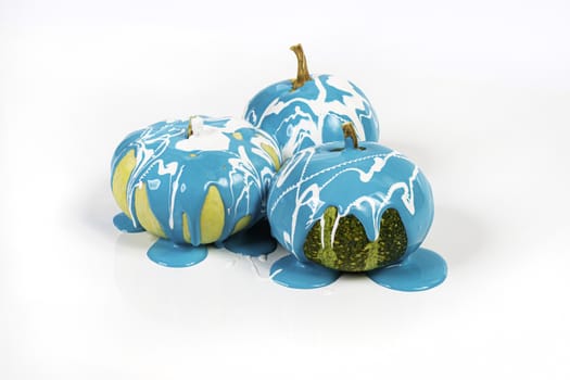 Some pumpkins with the blue color running down