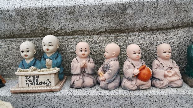 Closeup view of statues of religious monks. Buddha mini statue with beautiful background