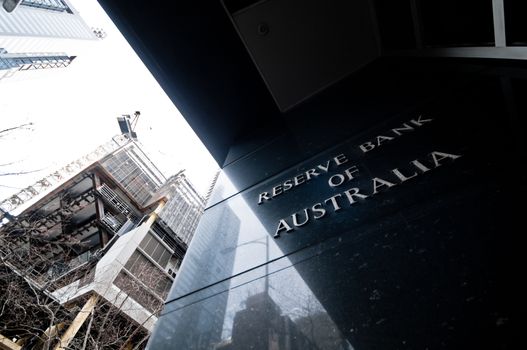 MELBOURNE, AUSTRALIA - JULY 26, 2018: Reserve Bank of Australia name on black granite wall in Melbourne Australia with a reflection of high-rise buildings. The RBA building is located at 60 Collins St, Melbourne VIC 3000 Australia.