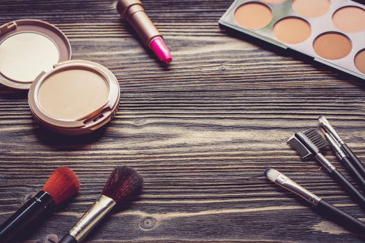 Top view a collection of cosmetic makeup on wooden table background, products cosmetic fashion concept, vintage retro style.