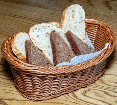 Black and white bread in a basket. Sliced ??bread in a basket. Pieces of bread are ready to eat