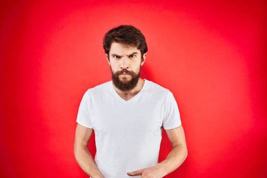 man in t-shirt gesturing with his hands dissatisfaction studio red uniform. High quality photo