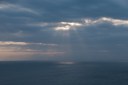 Heaven sun light shading from cloudy sky to the ocean