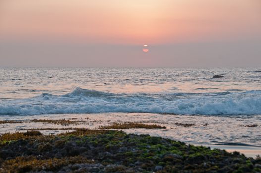 Evening sunset scene at Tanah Lot beach in Bali