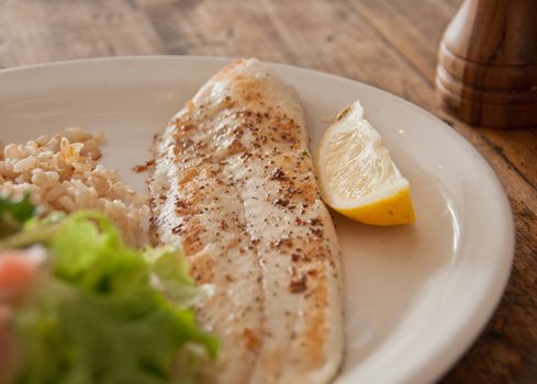 Grilled New Zealand cod fish and chips in a restaurant