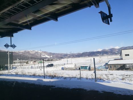 Far away train station in sunny day of Winter in Hokkaido Japan