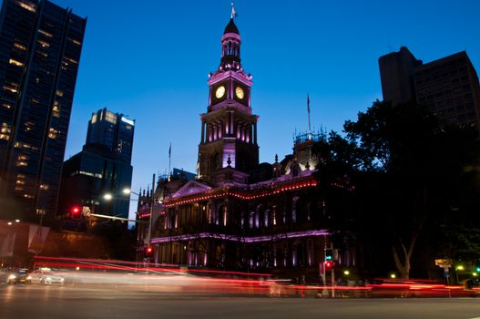 Light moving of bustling city center scene with old clock tower in Sydney