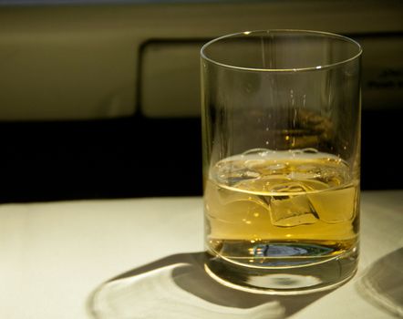 Golden malt whiskey served with ice on a table