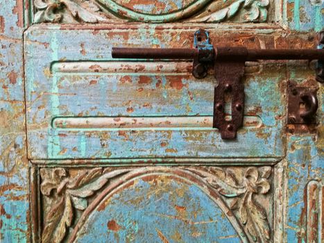 Morroccan vintage metal lock key on blue old door