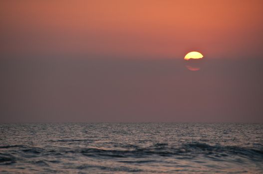 Big circle beautiful sunset on Bali sea in the evening