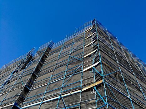 Construction scaffolding of high rise apartment with blue sky