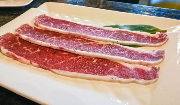 Think Wagyu beef steak slice on white plate