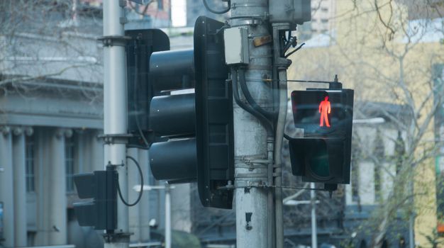 Red traffic light pole in Winter in Melbourne Australia