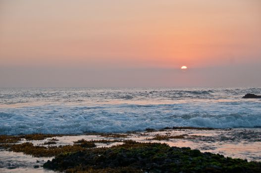 Wave and Sunset scene at Tanah Lot beach in Bali Indonesia