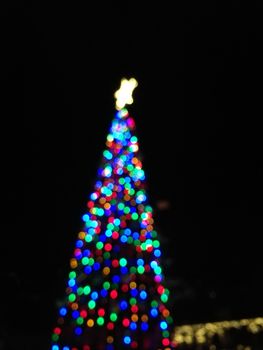 Defocused abstract light Christmas tree shape to celebrate Xmas and New Year Festival