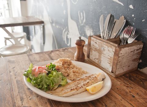 Grilled New Zealand cod fish and chips in a restaurant