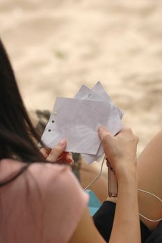 Lady sitting and holding a note on hands