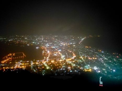 Misty cold snowy light night city scene from top of mountain in Hokkaido Hakodate Japan