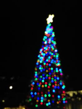 Defocused abstract light Christmas tree shape to celebrate Xmas and New Year Festival