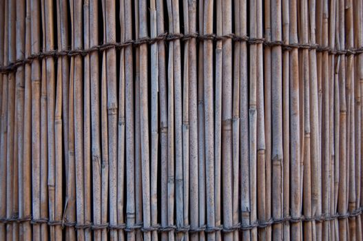 Stack wall of bamboo tubes wooden background