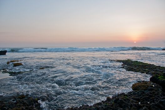 Wave and Sunset scene at Tanah Lot beach in Bali Indonesia