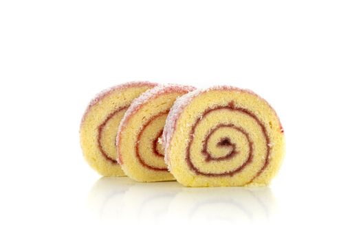 Colorful sponge roll cake with raspberry jam and coconut flakes, isolated on white background.